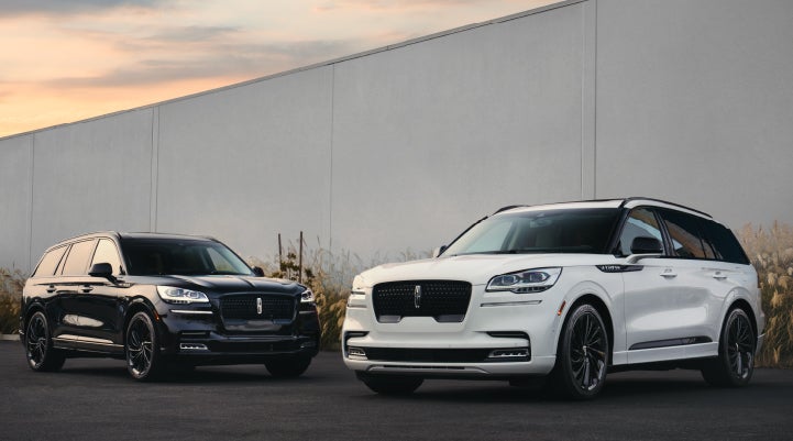 Two Lincoln Aviator® SUVs are shown with the available Jet Appearance Package | Klaben Lincoln of Warren in Warren OH